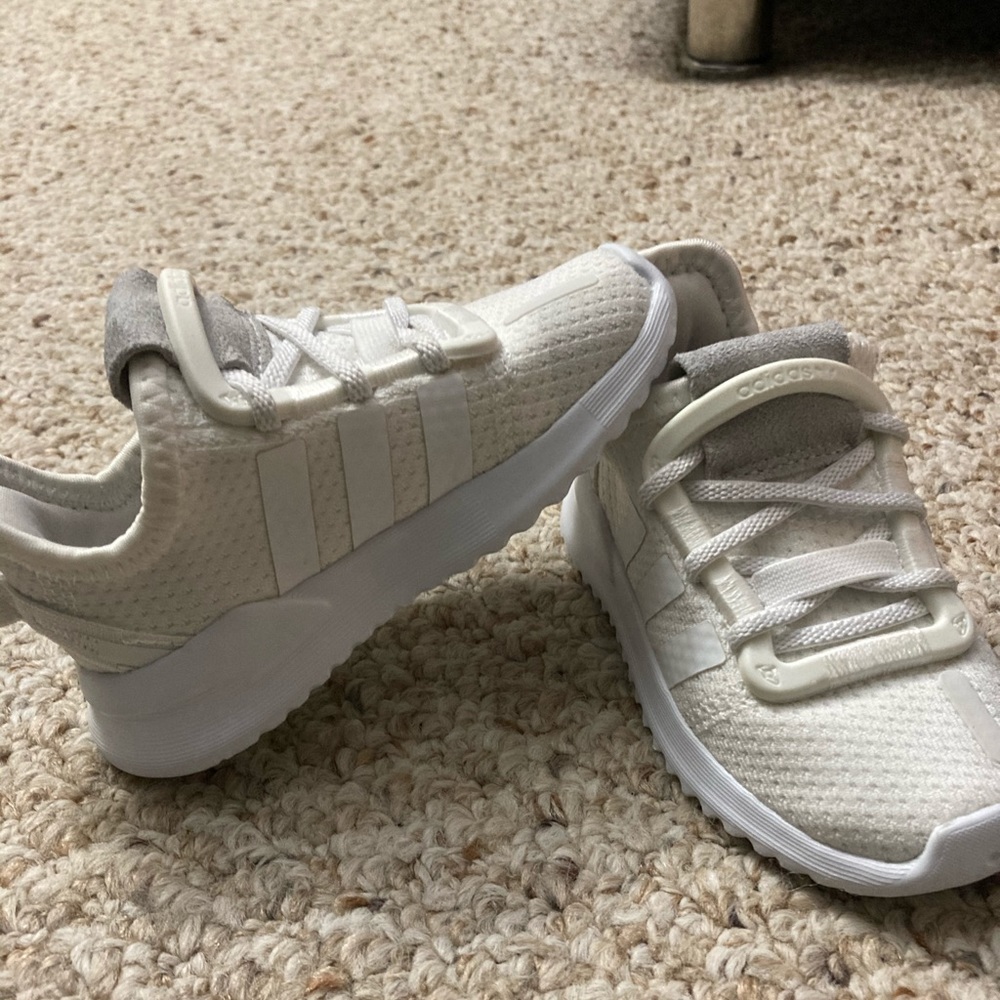 Baby boy used white adidas sneakers